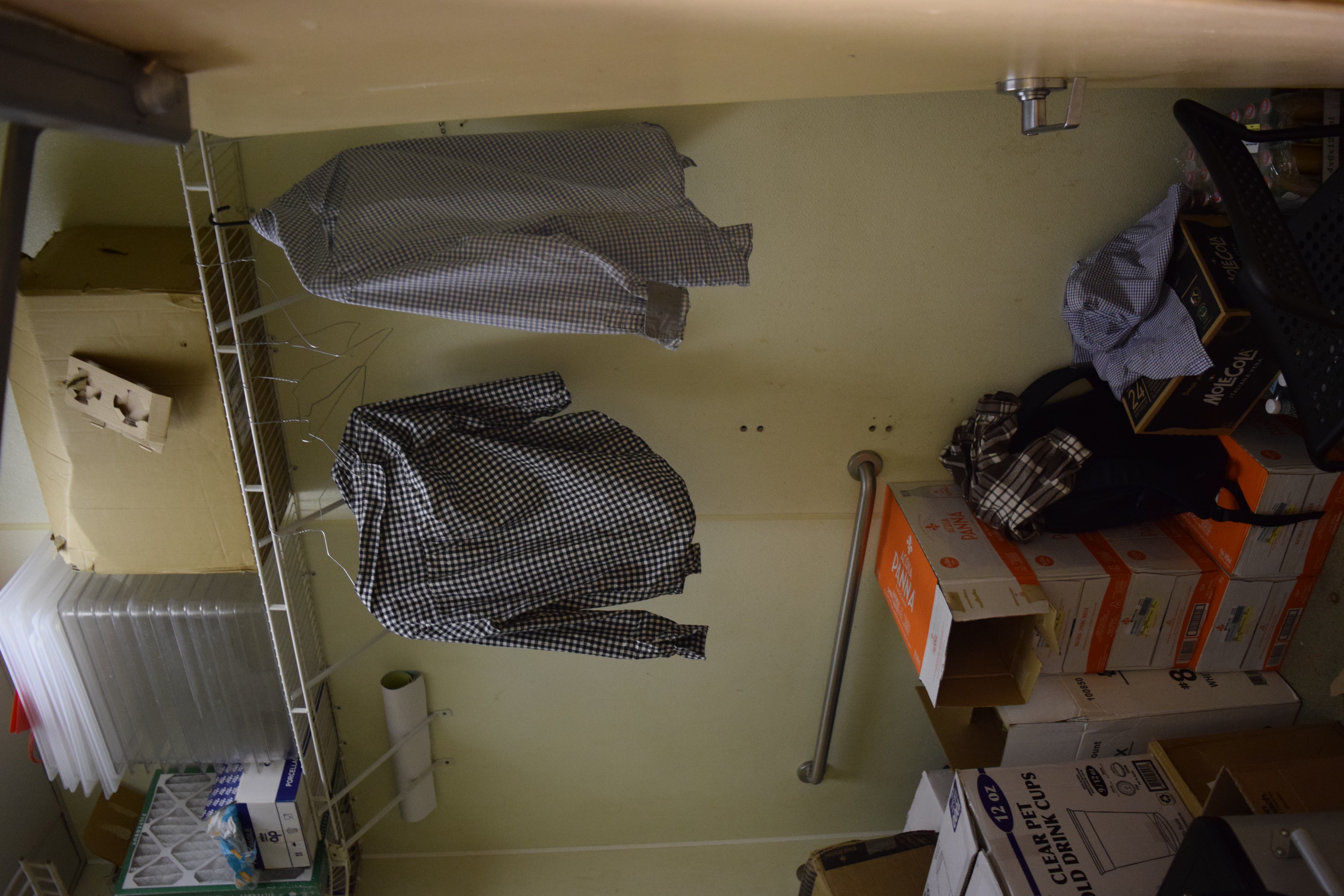 Stockroom shelving — unauthorized supplies and personal items mixed with operational stock