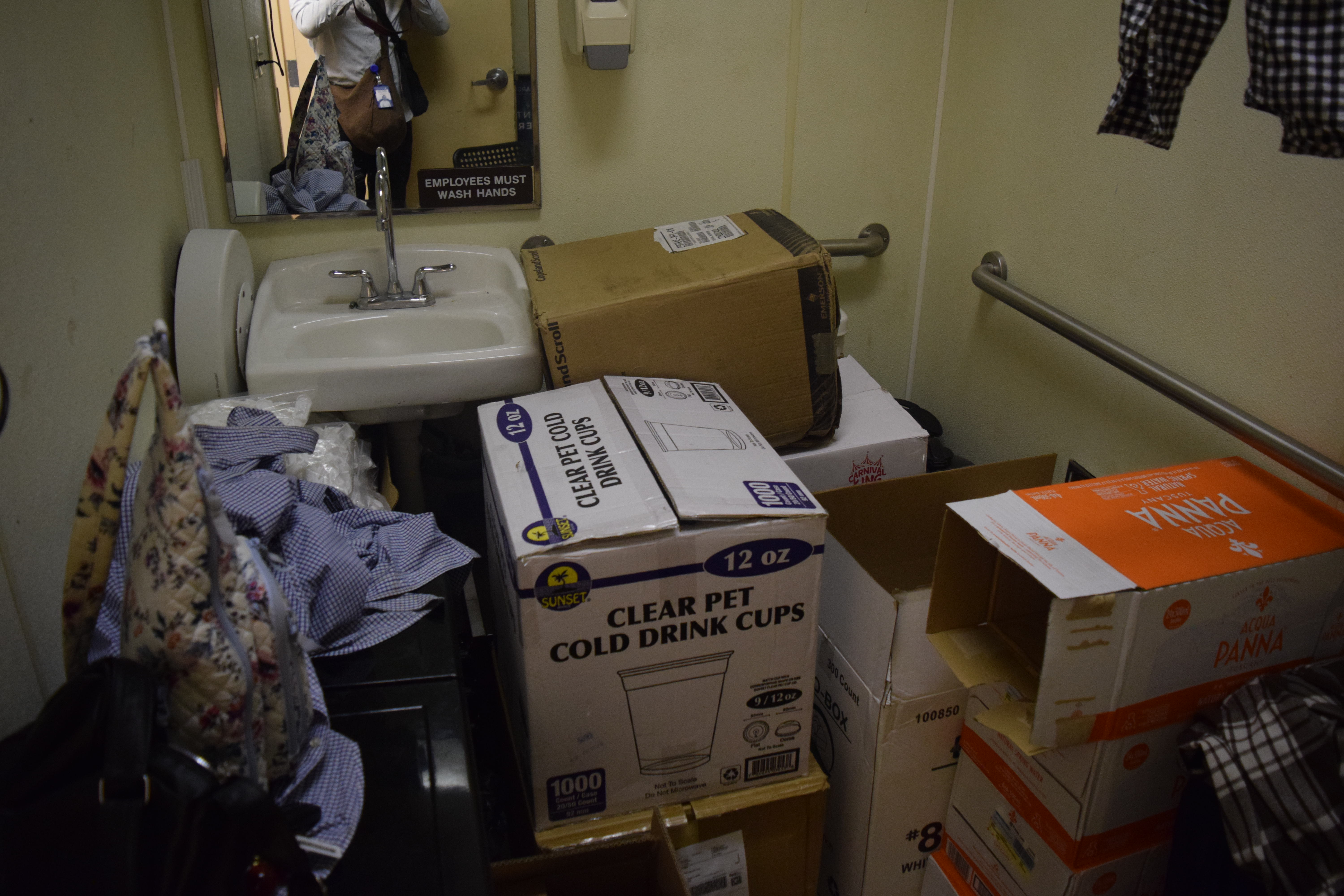 Above the storage room — torn boxes, dust, and disorganized inventory