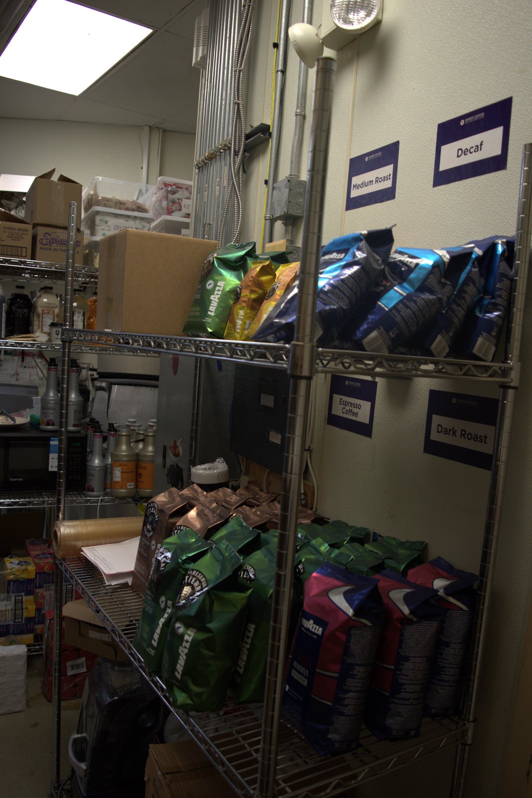 Coffee bean storage — Lavazza and other non-Qargo-approved coffee brands stocked under official Qargo Coffee shelf labels