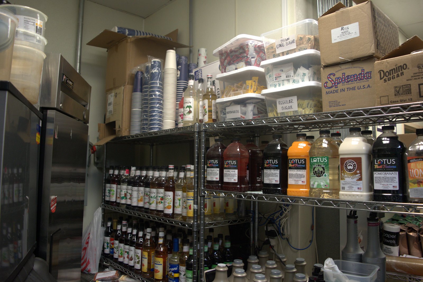 Syrup wall — large stock of Lotus Energy concentrates — unauthorized non-Qargo brand