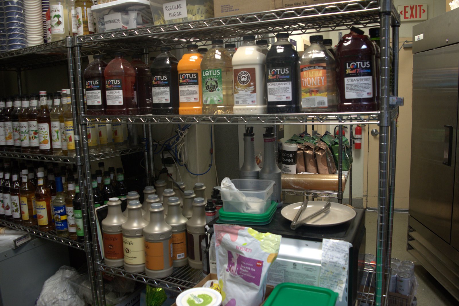 Wider syrup shelving — full inventory of unauthorized Lotus Energy bottles plus Monarch's Choice honey