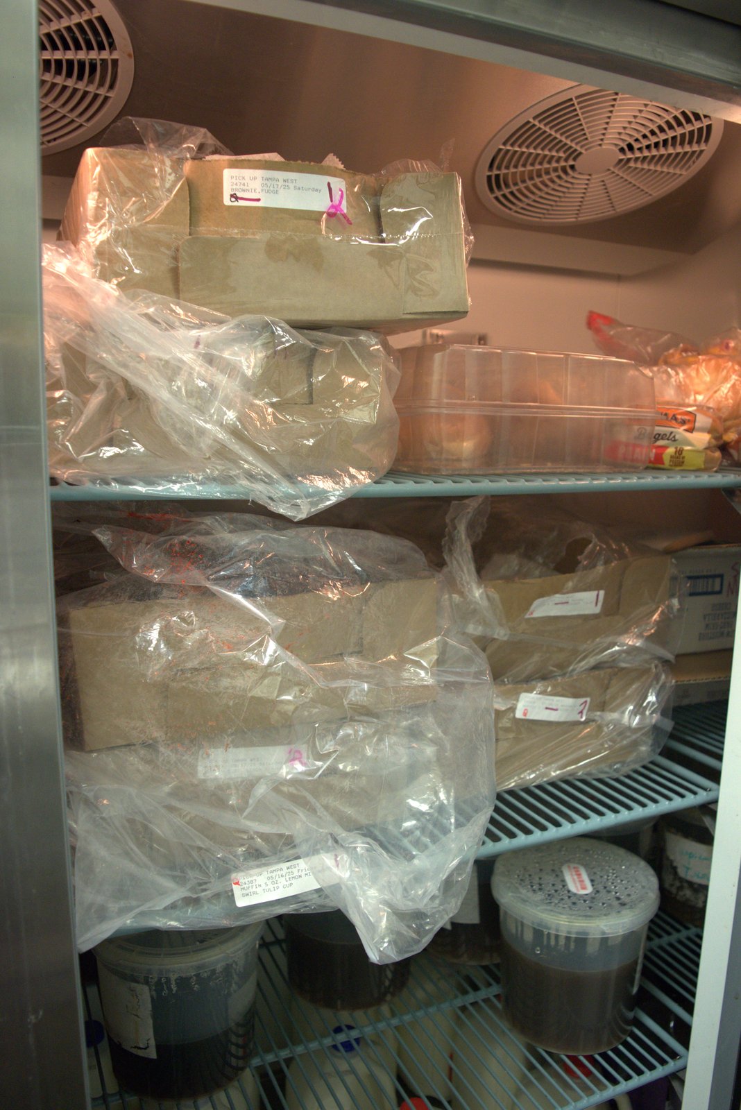 Bakery items labeled 'PICK UP TAMPA WEST 05/17/25' and '05/16/25' still being stored at the time of inspection