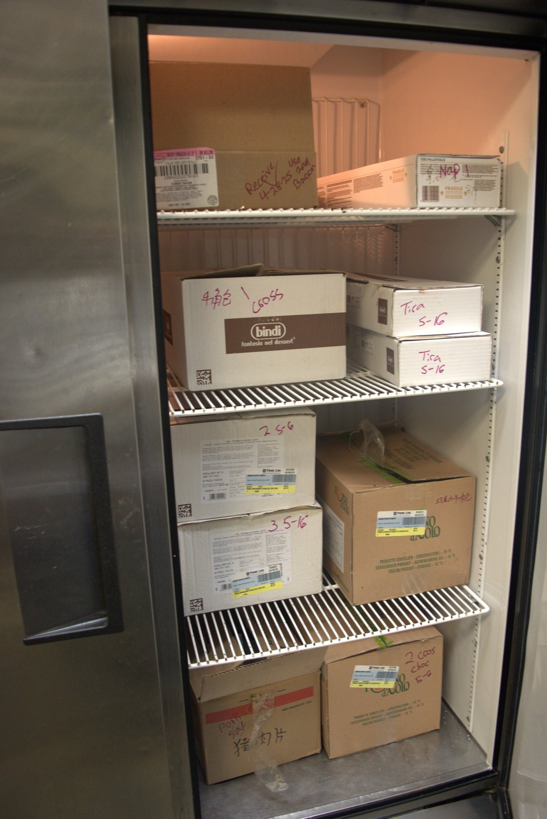 'Receive 4/28/25 Use 2nd Bacon' carton plus Chinese-language handwritten boxes indicating unauthorized products in cold storage