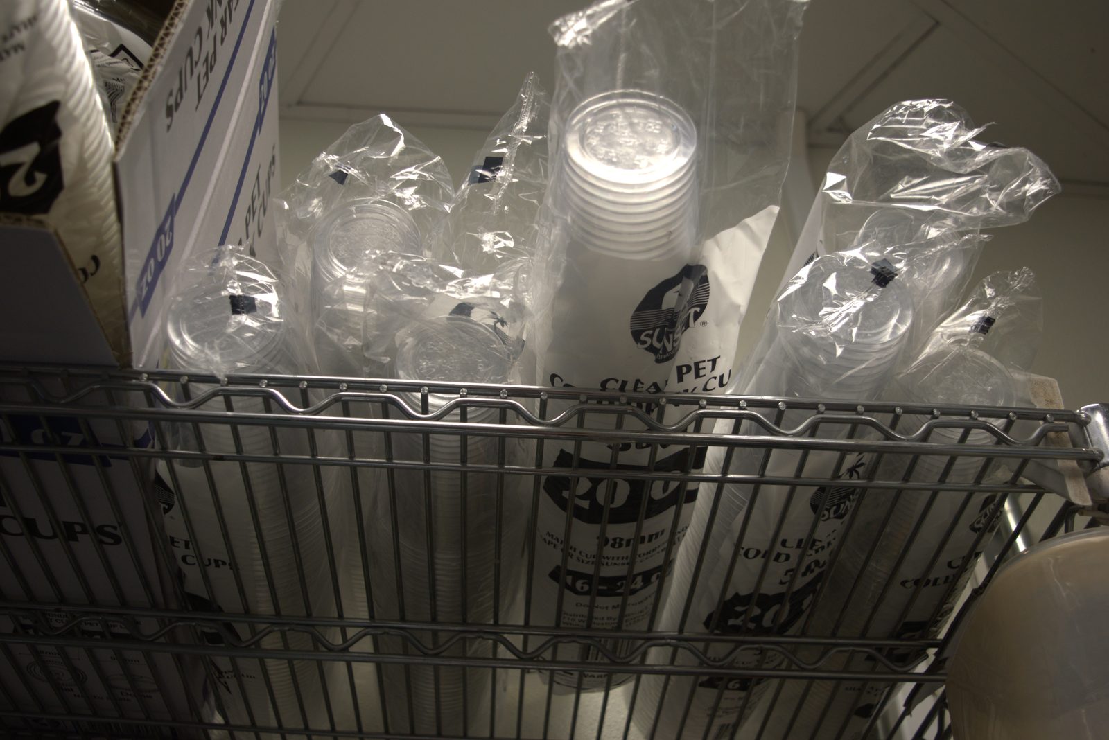 Disposables shelf — Sunset Brands sleeves only, no Qargo-branded cups visible anywhere on the rack