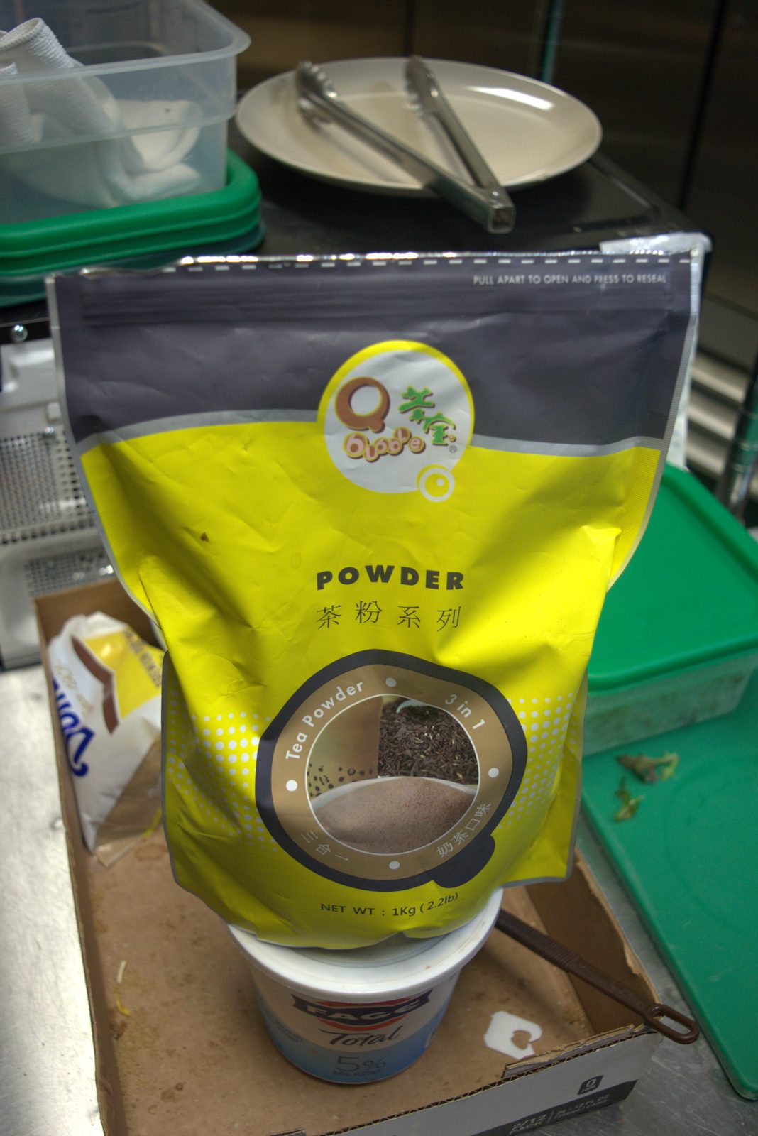 Unauthorized 'Qbubble' Chinese-import 3-in-1 milk-tea powder, opened and stored on a Fage yogurt tub