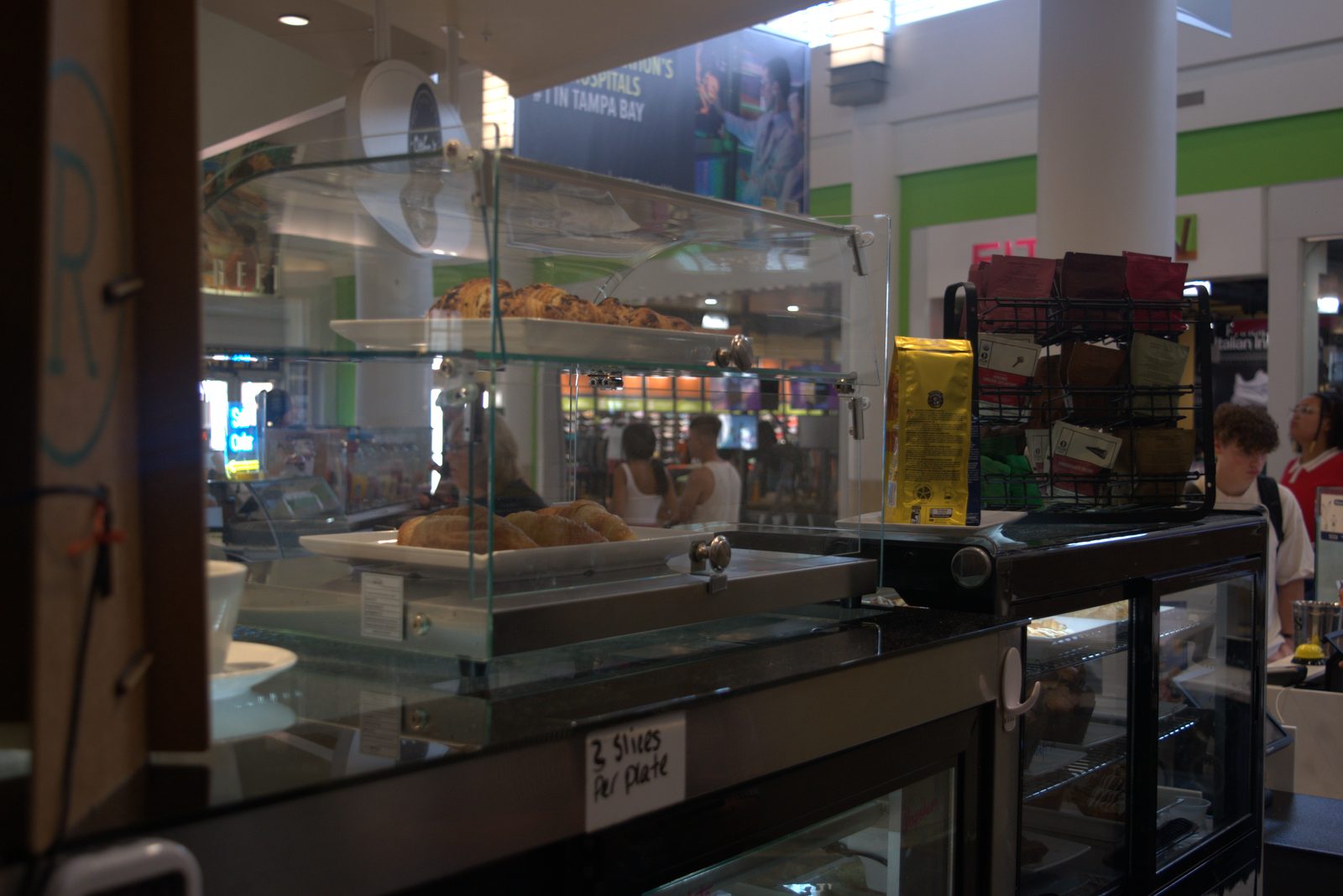 Front-of-house counter — yellow Lavazza coffee bag displayed for retail sale at a Qargo Coffee storefront