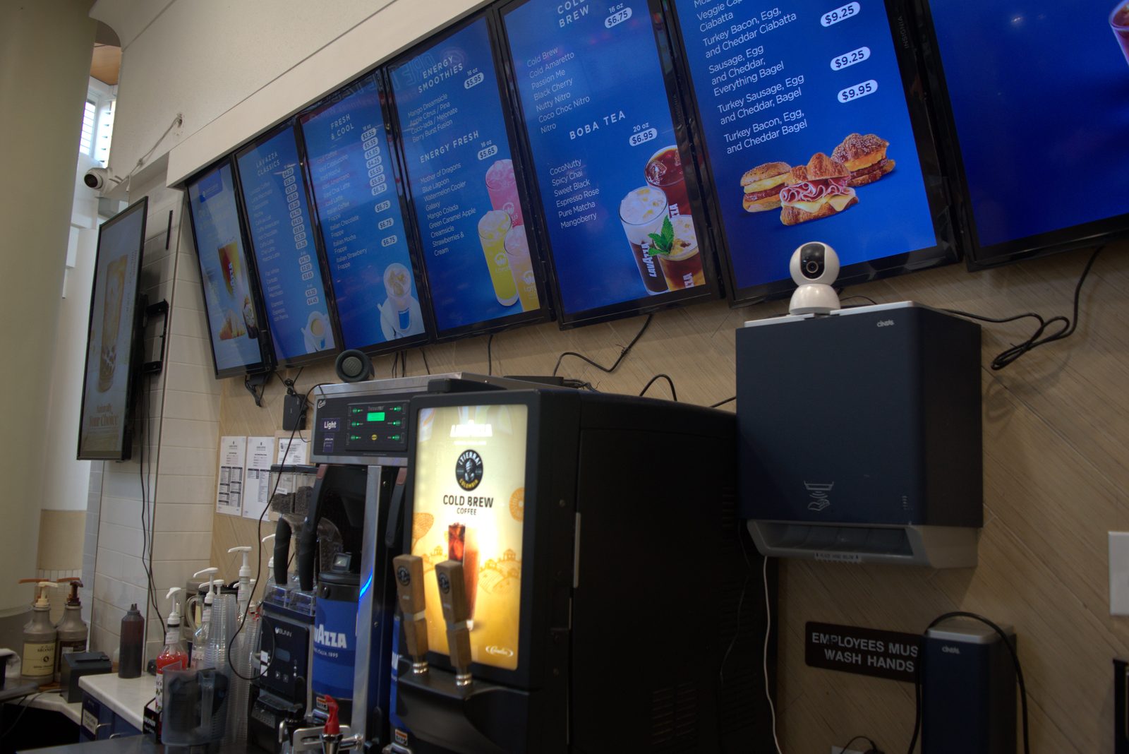 Wider menu-board view — multiple panels show Lavazza branding (smoothie image and Cold Brew section), confirming systematic substitution of Lavazza product imagery on the official Qargo Coffee menu