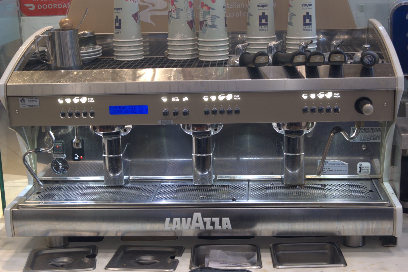 Three-group Lavazza espresso machine — full Lavazza-branded chassis as the primary espresso platform at the Qargo Coffee storefront