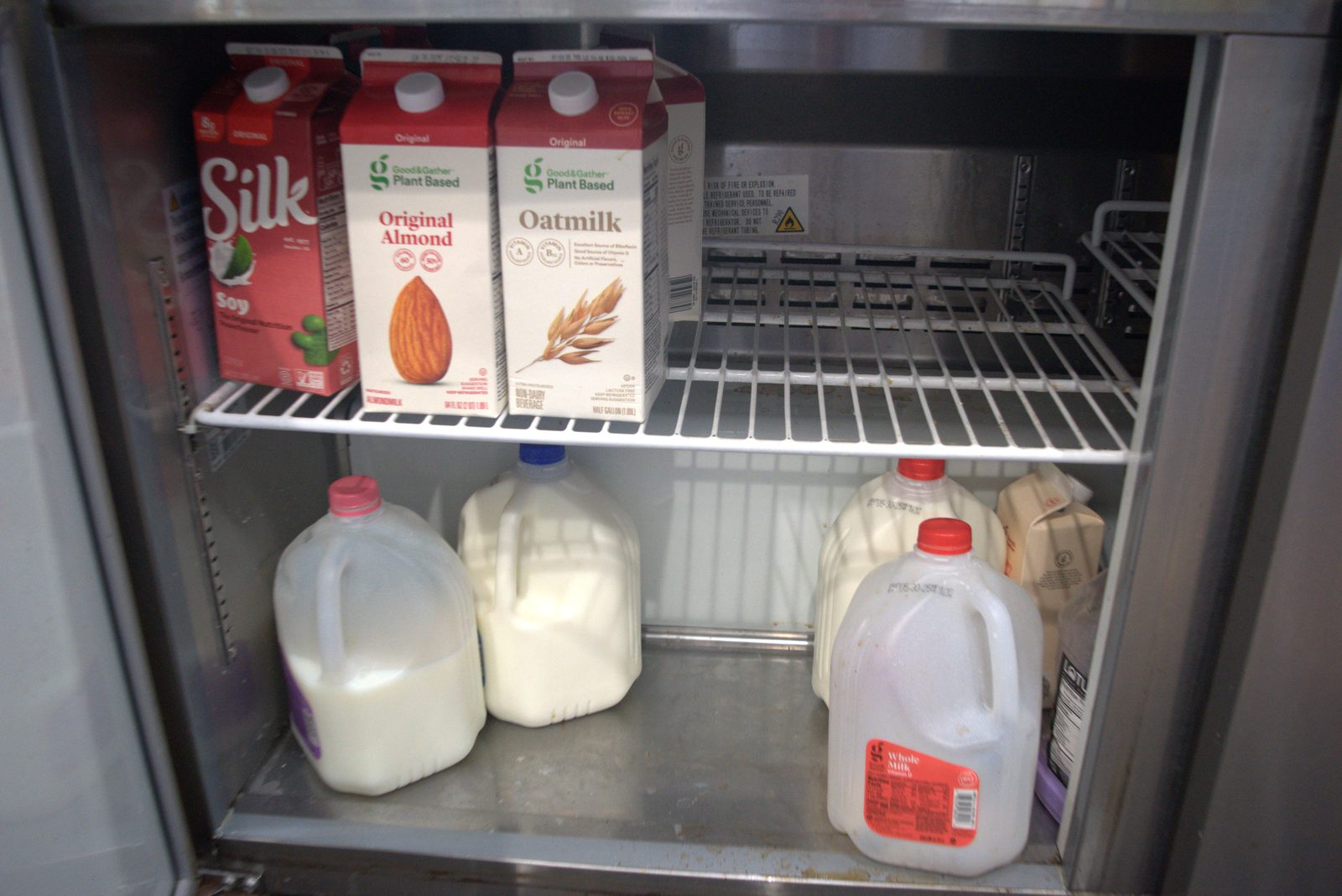 Reach-in dairy fridge — entire stock is retail-grade consumer dairy (Silk, Good & Gather); no foodservice SKUs