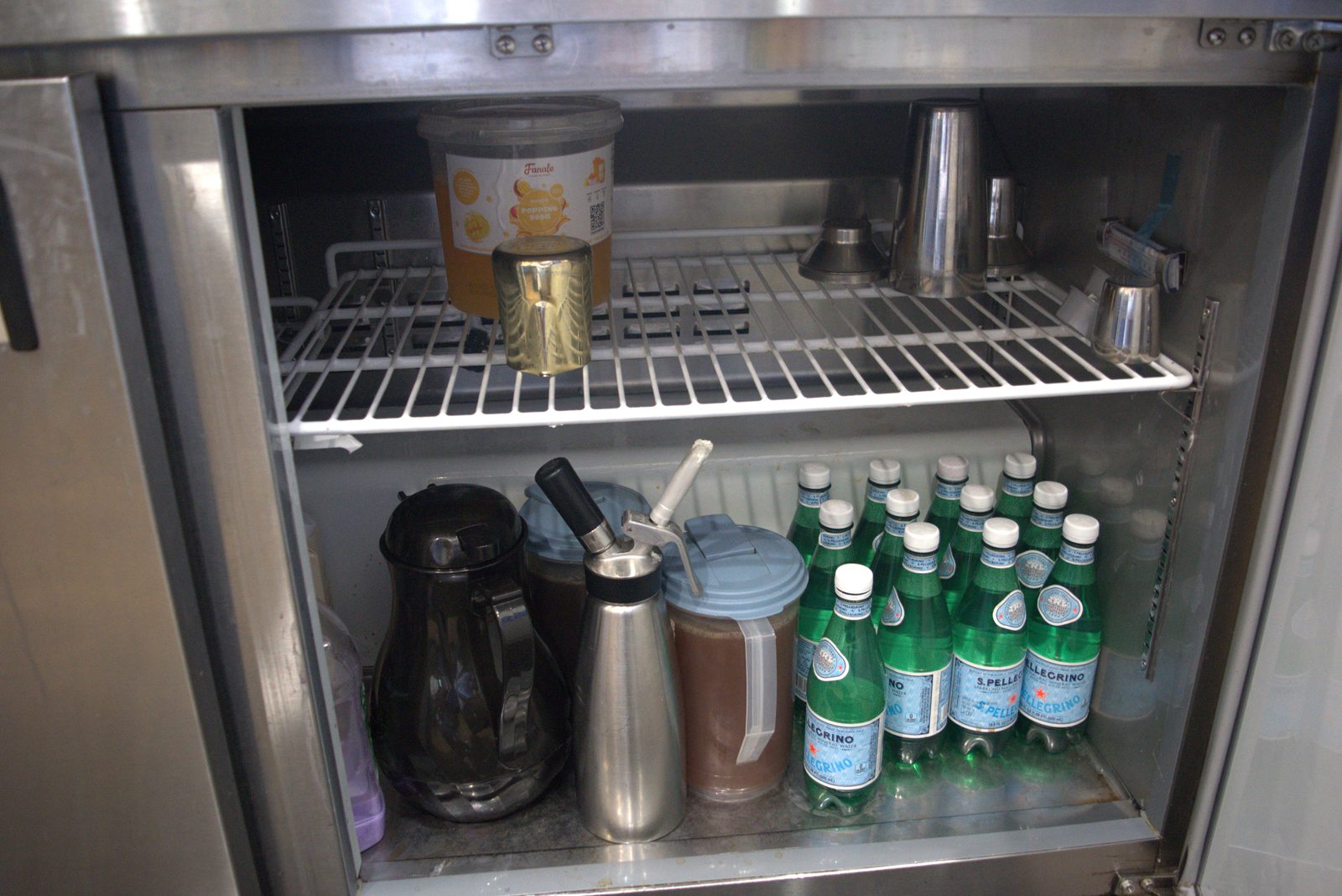 Under-counter prep fridge — 'Fanale' popping boba (unauthorized Asian-import topping) plus retail S. Pellegrino bottles