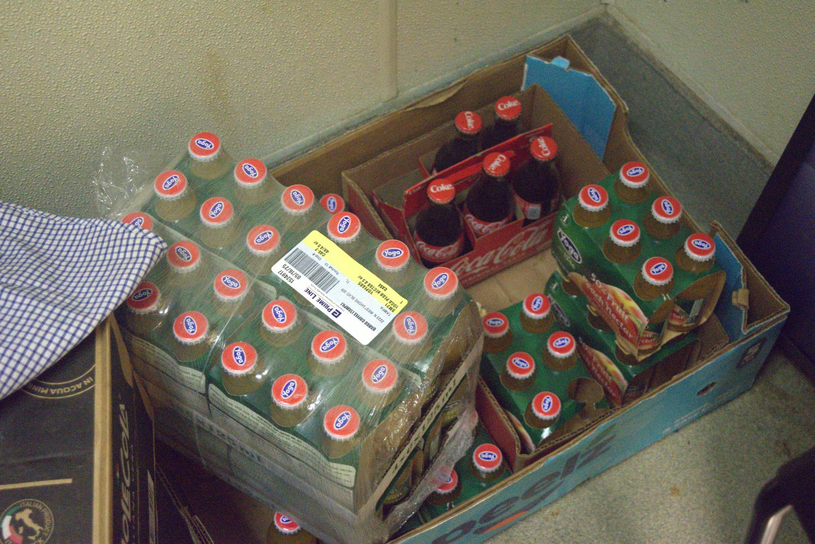 Yoga case bears the franchise-shipping label 'QARGO COFFEE TAMPA WS — 05/16/25' confirming unauthorized Italian juice stored at this location